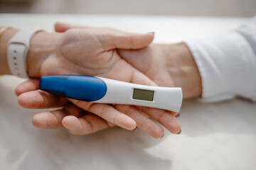 Man and woman holding pregnancy test