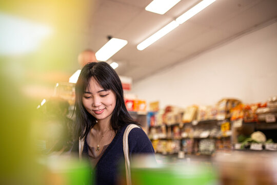 Young Asian woman shopping at the grocery store