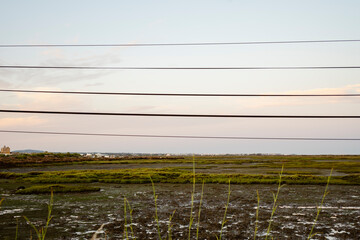 Abstract photo of power lines with beautiful natural park of Ria Formosa, Portugal