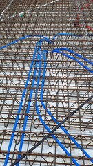 Embedded Electrical and Communication Conduits in Reinforced Concrete Slab Grid