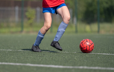 Girl Skillfully Dribbles Ball Between Flip Cups During Football Practice, Captured In Close-Up,...