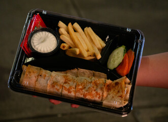 Take away box of shawarma with French fries and dipping sauce