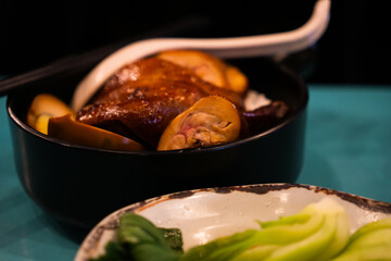 Taiwanese braised chicken with a glossy, caramelized skin served with steamed bok choy