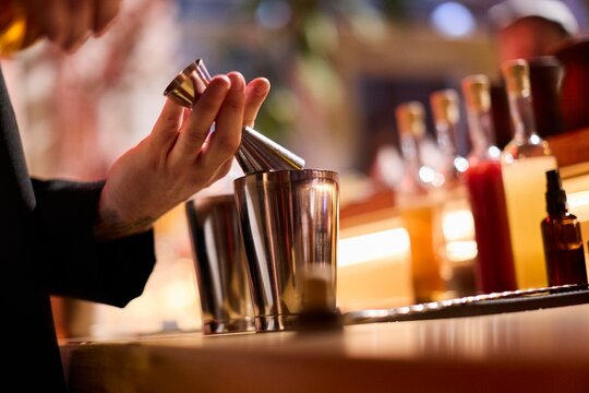 Bartender Preparing Cocktails at a Bar Counter - Powered by Adobe