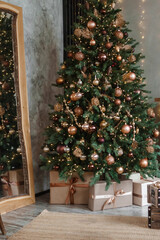 Home New Year's interior. Christmas tree with gifts, decorated with garlands in the kitchen. Cozy atmosphere of a home holiday, loft design of the room, Scandinavian style.