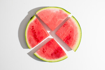 Juicy watermelon slices radiate like a summer solstice sunburst, invoking picnics, vitamin-rich...