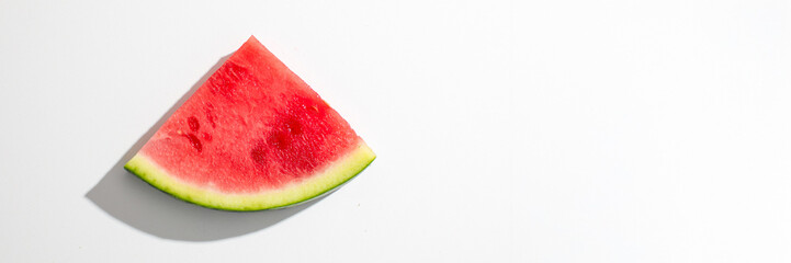 Juicy watermelon slice on minimalist white, evokes refreshing summer solstice picnics and quirky...