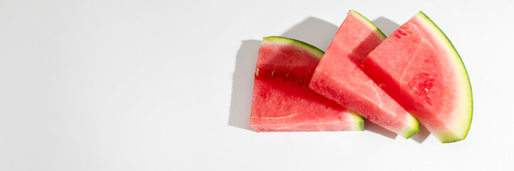 Slices of watermelon casting shadows, reminiscent of summer solstice feasts and refreshing...