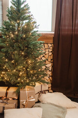 Designer Christmas tree decoration with lights. The concept of celebrating New Year and Christmas. Gifts in craft packaging under the Christmas tree.
