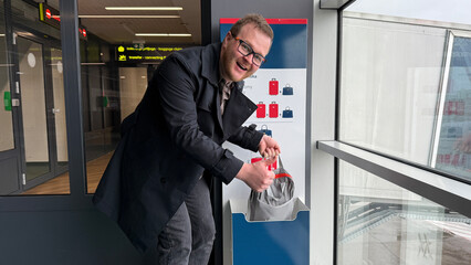 Smiling man of undetermined ethnicity enjoys quirkiest airport carousel shuffle, embodying Global...