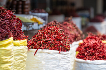 Red chilli pepper spices for sale on a spice market in Mumbai, India, fresh ingredients for cooking...