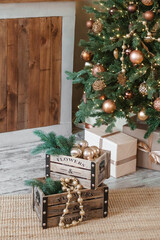 Home New Year's interior. Christmas tree with gifts, decorated with garlands in the kitchen. Cozy...