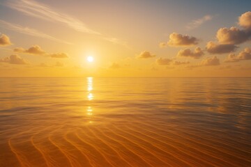 Obraz premium Serene golden ocean sunset with clear skies and gentle clouds reflecting on calm water surface, showcasing tranquil natural light and peaceful seascape.