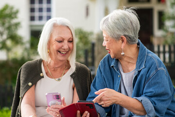 Seniors sharing stories about photos on their phone