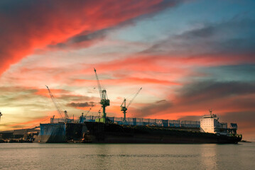 Industry landscape on sunset Engineering shipping crane depot at logistic export terminal control....