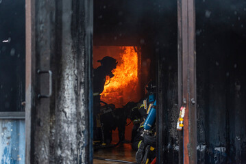 Firefighter Rescue team training fire fighting extinguisher. Teamwork Firefighter fighting with...