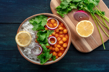 Chana masala, chickpea curry, traditional Indian dish, overhead flat lay shot with ingredients
