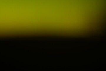 Abstract gradient background with transitioning tones of olive and black