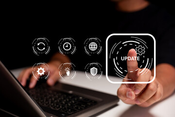 A person interacts with a virtual update interface while using a laptop, emphasizing software...