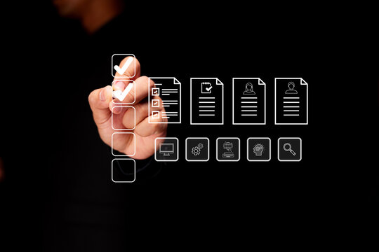 A hand selects a checklist icon from a digital interface displaying various document and user icons on a transparent screen. - Powered by Adobe