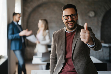 Happy businessman in his office