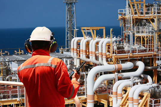 Technician monitor and command by radio to operator on job site in oil and gas industry, Worker in oil and gas industry contact to operation team to check condition of the machine, Maintenance work.