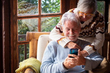 Senior couple in their 70s spending calm and quality time together in a cozy mountain chalet. A...