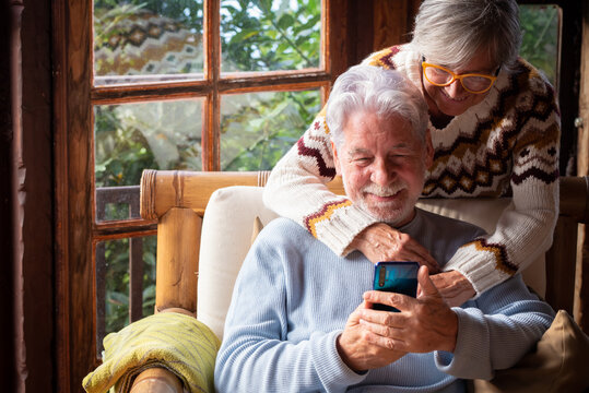 Senior couple in their 70s spending calm and quality time together in a cozy mountain chalet. A serene and intimate atmosphere of connection, wellness, and joy in quiet, mindful shared moments