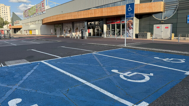 Warsaw, Poland - June 19,2025: Accessible parking spaces marked for people with disabilities in front of shopping center
