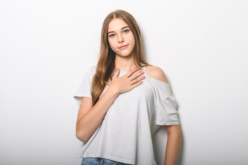 Portrait of teenage girl in casual t-shirt on light background in studio.