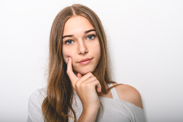 Fototapeta premium Portrait of teenage girl in casual t-shirt on light background in studio.