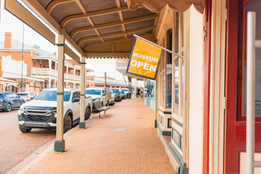 Museum Open sign along footpath in main street of small historic Australian town