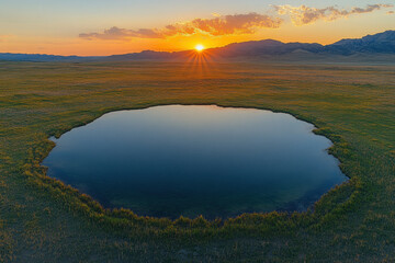 Obraz premium Aerial view of the honeycomb pattern formed by water pools on flat ground, with a sunset in the background. The reflections create an intricate and mesmerizing scene. generative ai