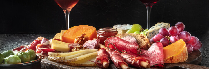 Antipasti or tapas panorama. Charcuterie and cheese board with olives. Spanish and Italian gourmet...