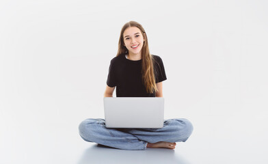 Naklejka premium Portrait of teenage girl in casual black t-shirt on light background in studio.