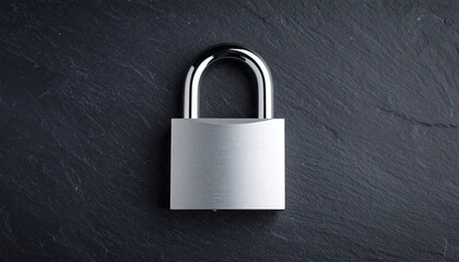 Fototapeta premium Silver metal padlock on dark textured stone backdrop.