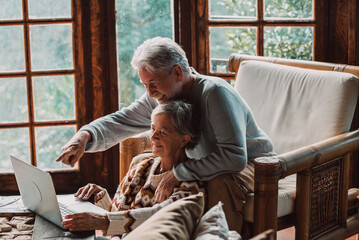 Senior couple in their 70s spending calm and quality time together in a cozy mountain chalet. A...