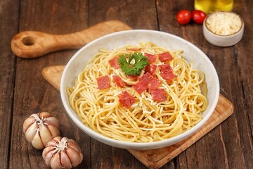 Spaghetti Carbonara is an Italian dish consisting of spaghetti pasta cooked with heavy cream sauce, cheese and meat.
