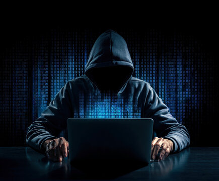 A shadowy figure in a hoodie sits before a laptop, surrounded by streams of binary code, representing the ominous world of hacking and cyber threats in the digital age.