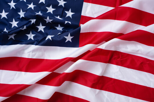 Close-up View of a Draped American Flag Red, White, and Blue Stripes and Stars - Powered by Adobe