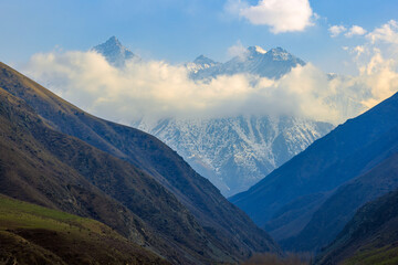 Majestic snow-capped mountains under cloudy sky in Kyrgyzstan