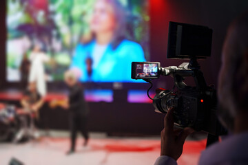 videographer and Flip-up screen of a professional video camera.