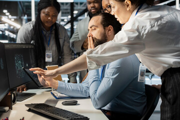 Team of admins working together in server hub, analyzing rigs data. Data center office IT...