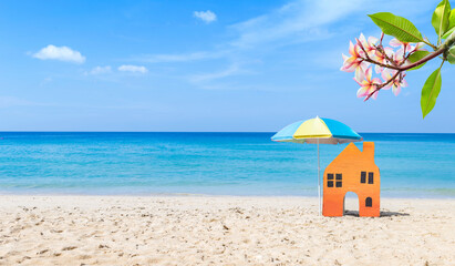 Miniature house on tropical beach, summer outdoor day light, property and real estate business