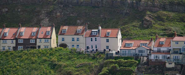 Whitby is a seaside town in Yorkshire, northern England, split by the River Esk. On the East Cliff,...