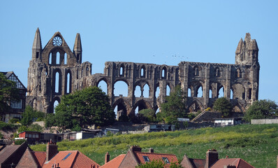 Whitby is a seaside town in Yorkshire, northern England, split by the River Esk. On the East Cliff, overlooking the North Sea, the ruined Gothic Whitby Abbey was Bram Stoker’s inspiration for “Dracula