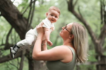 Happy family on a summer meadow. little girl child baby daughter with mother
