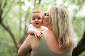 Happy family on a summer meadow. little girl child baby daughter with mother
