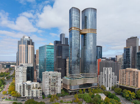 Aerial view of tall city skyscrapers joined by an aerial walkway