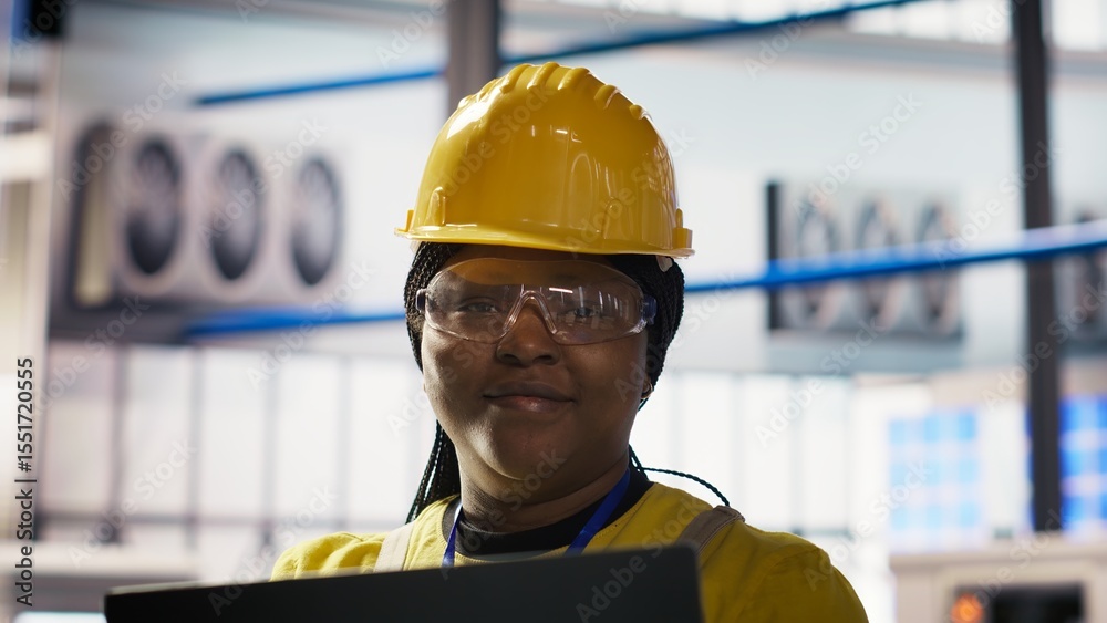 Poster smiling smart factory specialist testing automated systems to ensure reliability. happy engineer in 
